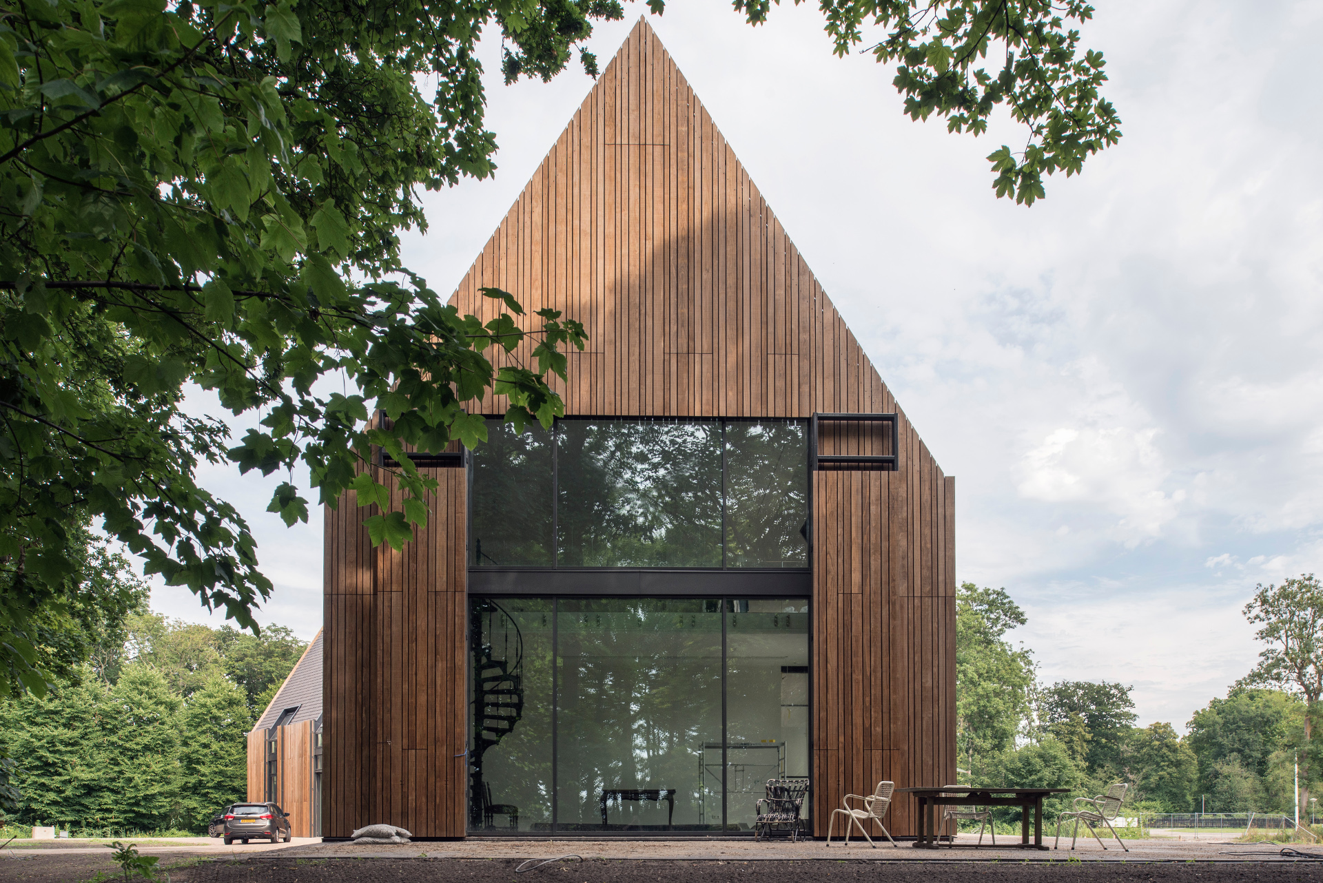 hoog huis met puntdak en houten gevel