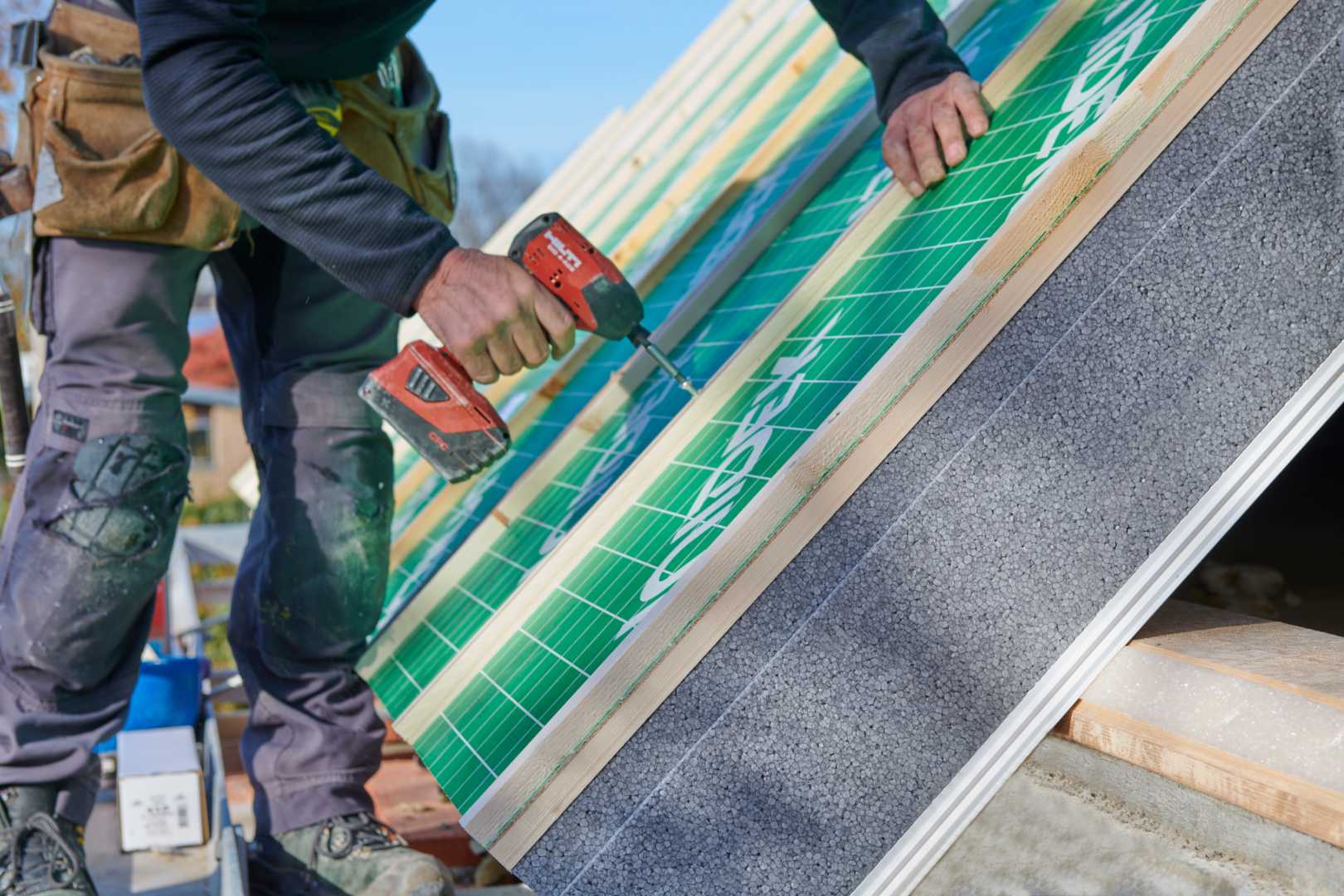 Unidek pasdak Vught Bouwvakker brengt isolatie aan op een dak
