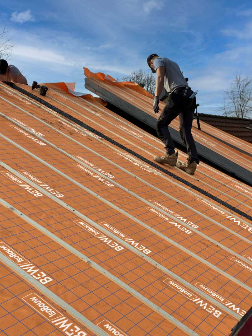 Bouwvakker controleert het aanbrengen van isolatie
